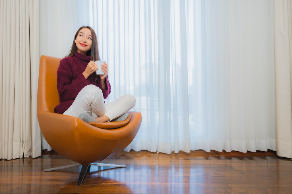 portrait-beautiful-young-asian-woman-smile-relax-sofa-living-room-interior_74190-12422