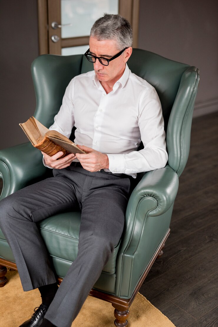 elderly-businessman-reading-armchair_23-2148116268