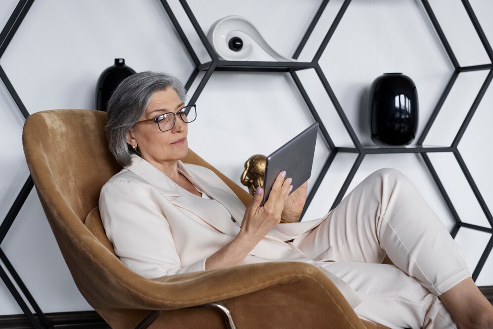 side-view-woman-sitting-chair-with-tablet_23-2149429136